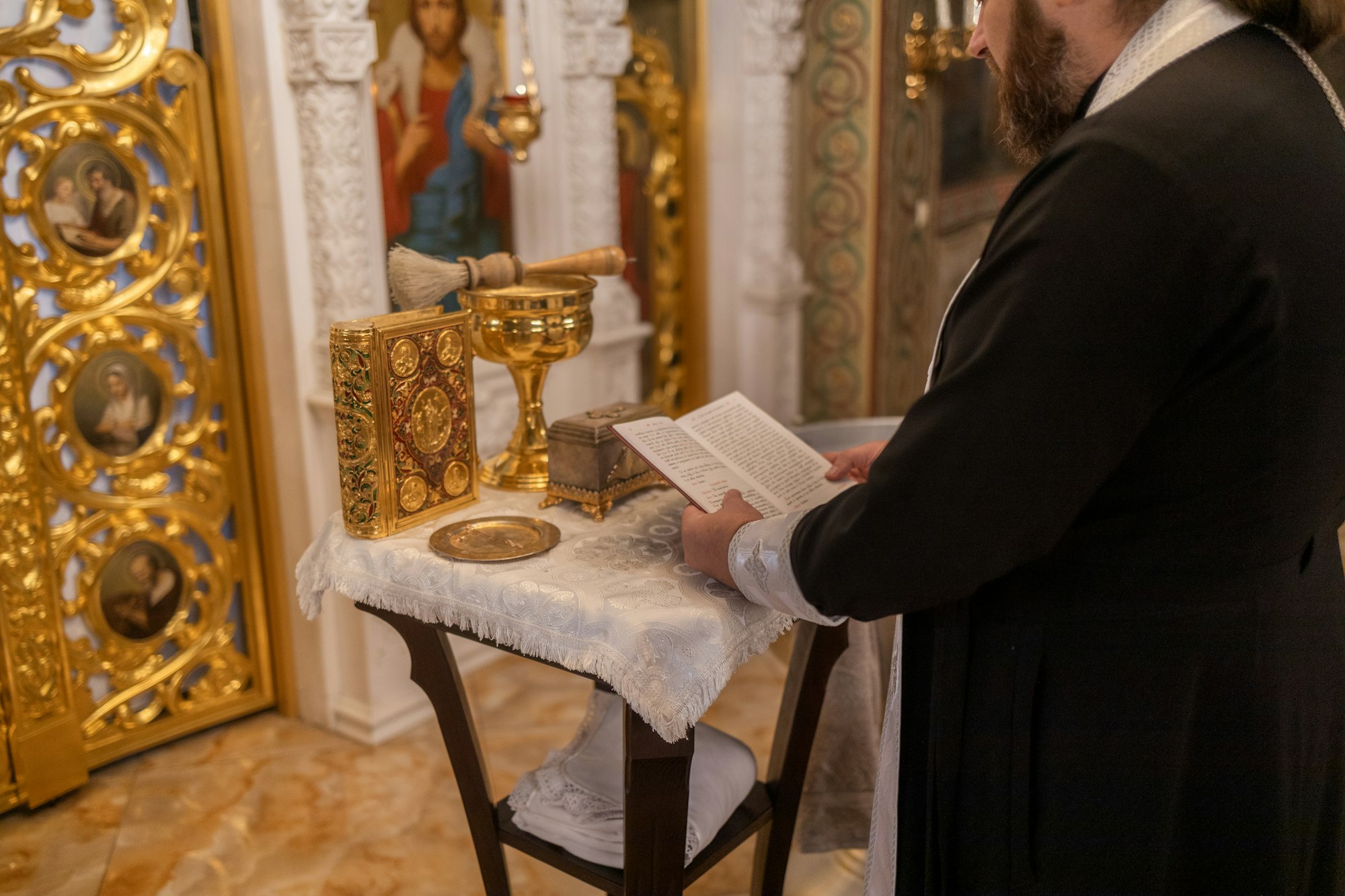 In Christian Church: Close Up of The Bible, Gospel of Jesus. Minister Leads The Congregation In Pray