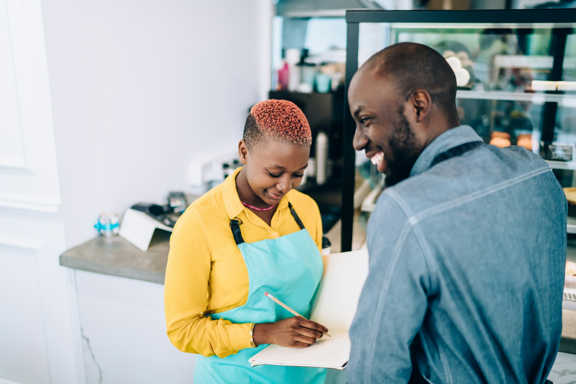 Smiling happy black coworkers of cafeteria